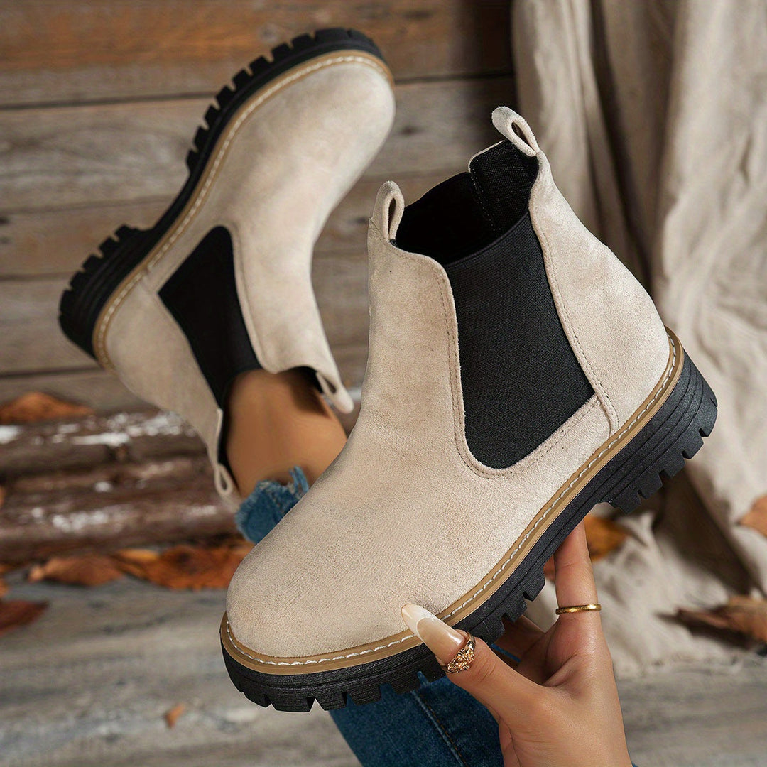 Beige Chelsea boots shown from above, soles facing camera