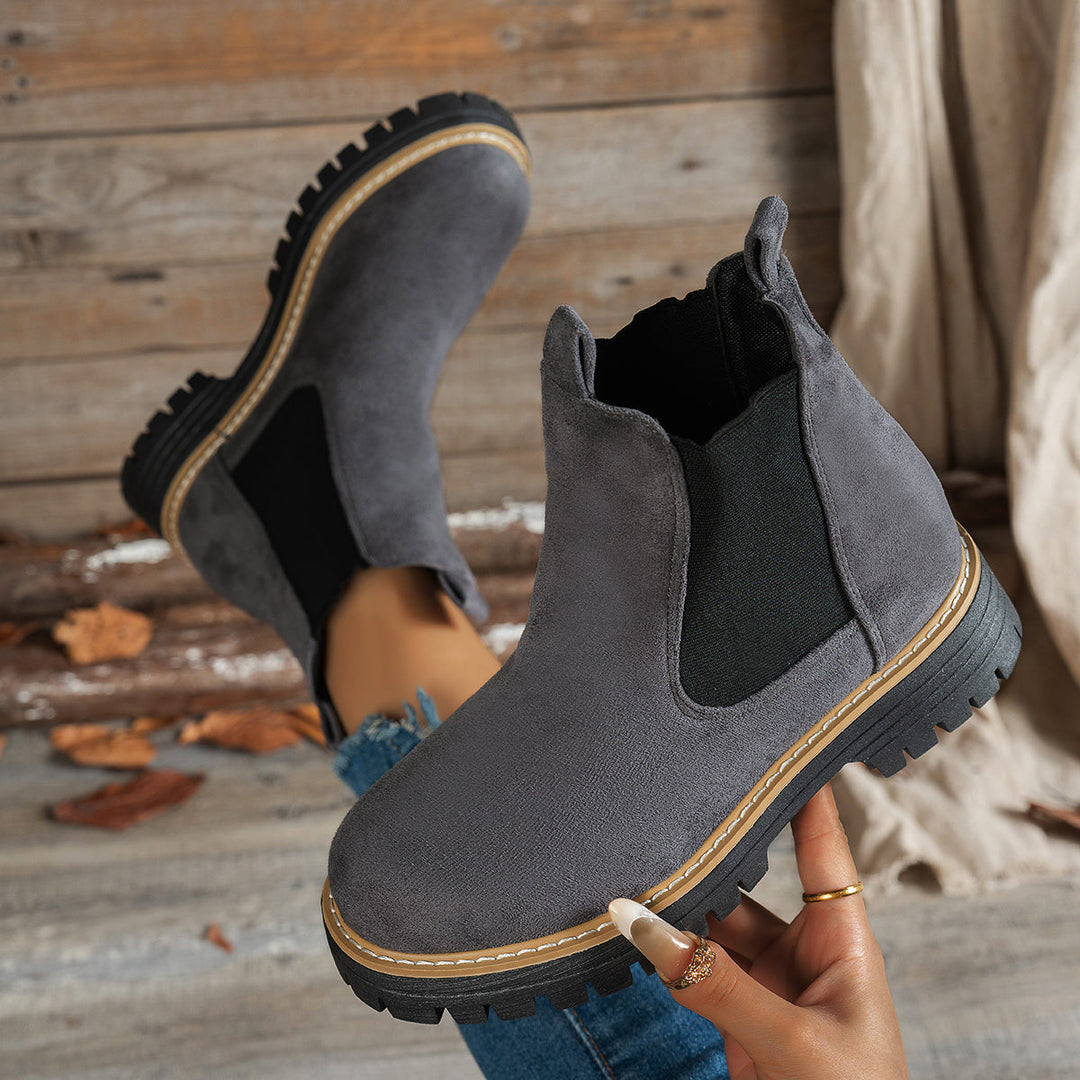 Grey Chelsea boots shown from above, soles facing camera