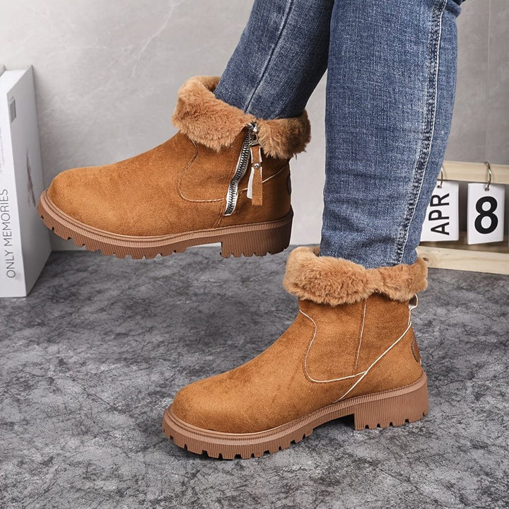 Wren fur lined ankle boots in tan suede with folded fur cuff, side view