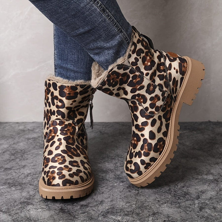 Wren fur lined ankle boots in leopard print, angled view on model