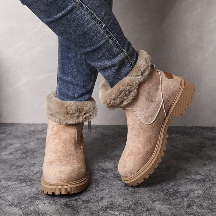 Wren fur lined ankle boots in beige suede with folded fur cuff, close-up angled view